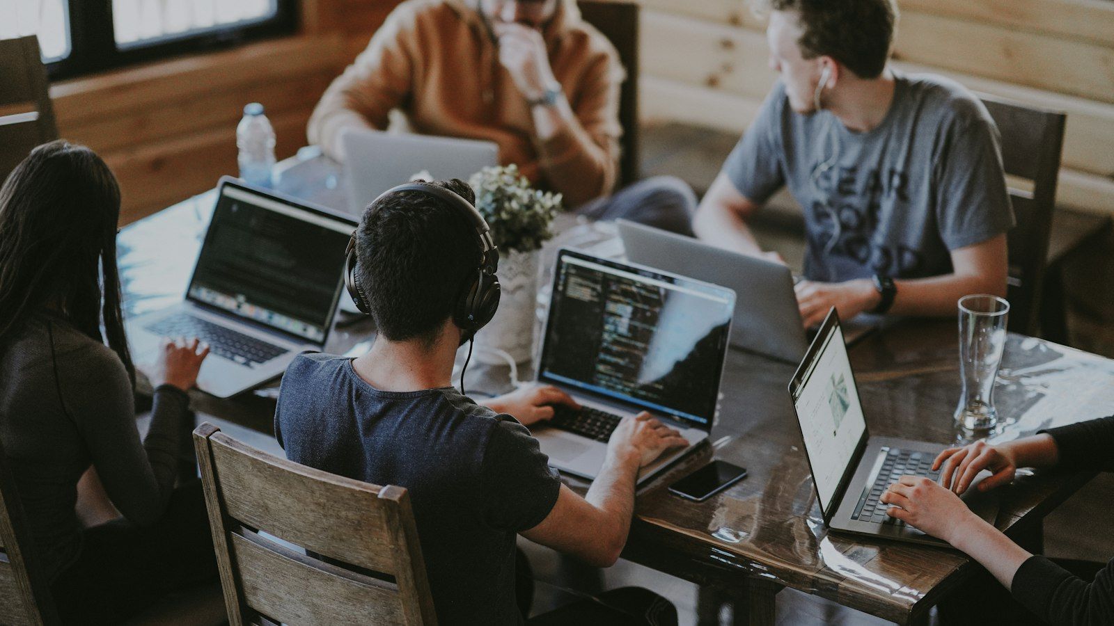 A team planning a sprint around a laptop with notes and charts
